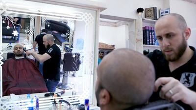 At Al Sham Flower Salon in Khalidiya, Eissa Al Mazrouei's barber uses tools provided by the salon. For years, Mr Al Mazrouei used to bring in his own, a habit he has now grown out of. Ravindranath K / The National