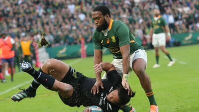 Caleb Clarke of New Zealand is tackled by South Africa's Lukhanyo Am. EPA