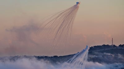 Israeli shells that appear to be white phosphorus explode over Dahaira, a Lebanese border village on October 16. AP