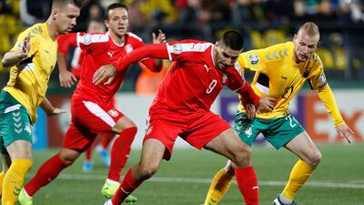 Serbia's Aleksandar Mitrovic, centre, and Lithuania's Modestas Vorobjovas, right, challenge for the ball during their Euro 2020 Group B qualifying match at the LFF stadium in Vilnius. AP