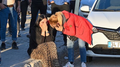 People gather outside Turkish Aerospace Industries Industries. AP