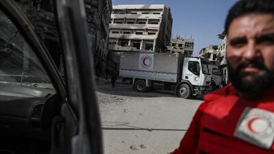 Volunteers with Syrian Arab Red Crescent (SARC) unload aid trucks in Douma, in Eastern Ghouta, Syria, on March 5, 2018. Mohammed Badra / EPA