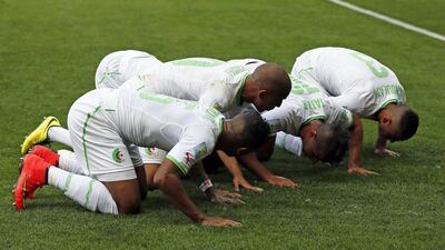 Algeria's Sofiane Feghouli, second left, celebrates with teammates after his penalty kick goal on Tuesday against Belgium at the 2014 World Cup in Belo Horizonte, Brazil. Dennis Sabangan / EPA / June 18, 2014