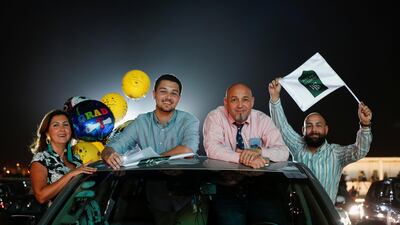 Family members celebrate from their car during the event. Reuters