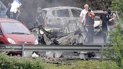 Police officers investigate the scene of the car bomb in Bilbao.
