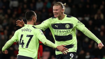 Manchester City's English midfielder Phil Foden (L) celebrates scoring his team's third goal with Norwegian striker Erling Haaland (R) during the English Premier League football match against Bournemouth. AFP.
