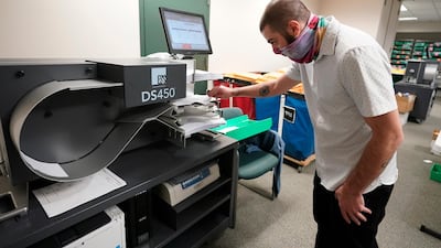 Lehigh County worker uses a scanner to count ballots. AP