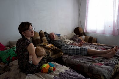Ira with her daughter and her companion Sasha. They have lived with their two children in Ivanhrad for the past six years, after leaving Donetsk at the height of the fighting in 2014. Marion Pehee for The National