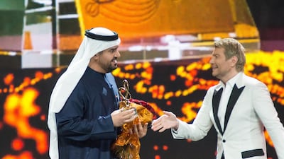 Hussain Al Jassmi receives the award for Best Middle East Artist from Nikolay Baskov at the Bravo awards in Moscow, Russia on Saturday night.