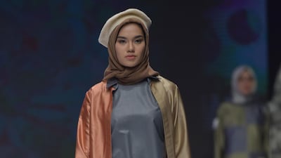 Novia Sukijo combines beret with headscarf. AFP