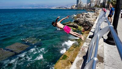 A young boy dives into the sea in Beirut. AFP