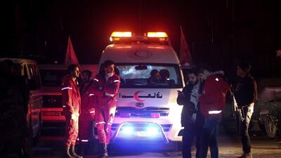 Syrian staff from the International Committee of the Red Cross take part in a medical evacuation operation in Douma in the eastern Ghouta region on the outskirts of the capital Damascus. Amer Almohibany / AFP Photo