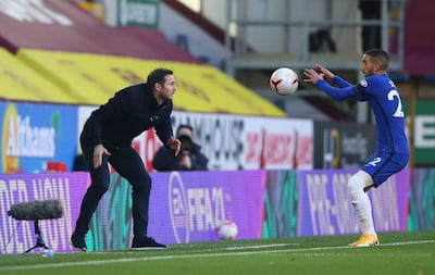 BURNLEY, ENGLAND - OCTOBER 31: Frank Lampard, Manager of Chelsea passes the ball to Hakim Ziyech of Chelsea during the Premier League match between Burnley and Chelsea at Turf Moor on October 31, 2020 in Burnley, England. Sporting stadiums around the UK remain under strict restrictions due to the Coronavirus Pandemic as Government social distancing laws prohibit fans inside venues resulting in games being played behind closed doors. (Photo by Alex Livesey/Getty Images)