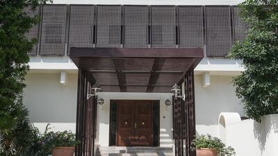 The residence has a wraparound balcony that is shaded by traditional screens, or mashrabiya, which not afford privacy but also reference the traditional architecture of the region. Mona Al Marzooqi / The National