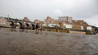Yemeni children walk through a flooded street following heavy rains in the old quarter of Sana'a, Yemen. EPA