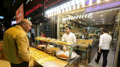 Syrians work at an eastern sweets restaurant in an area called 6 October City in Giza, Egypt, March 19, 2016. Reuters