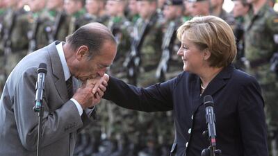 French President Jacques Chirac kisses the hand of German Chancellor Angela Merkel upon his arrival at the Chancellery on May 3, 2007 in Berlin, Germany. Getty Images