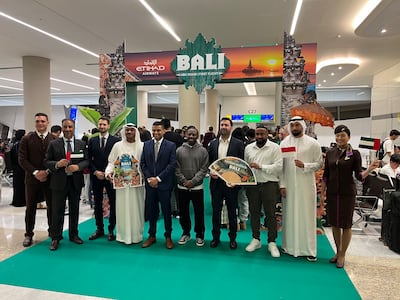 Etihad representatives and cabin crew, with former football player Shaun Wright-Phillips, centre, celebrate the inaugural flight at Zayed International Airport. Evelyn Lau / The National