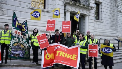 Members of the Public and Commercial Services union on the picket line outside the UK Treasury in Westminster. PA
