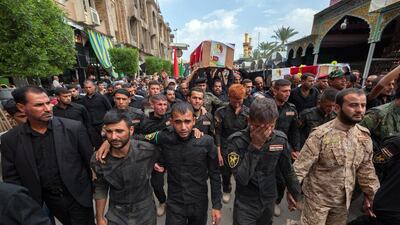 Members of the Iraqi security forces carry the coffins of their comrades during a procession to their burial site in Iraq's Shiite shrine city of Karbala on Monday. Mohammed Sawaf / AFP