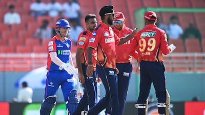 Punjab Kings' players celebrate after the dismissal of Delhi Capitals' David Warner. AFP