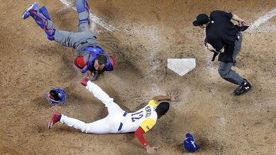 Welington Castillo of the Dominican Republic tags out Oscar Mercado of Colombia during a pool game at the World Baseball Classic in Miami. Mike Ehrmann / Getty Images / AFP