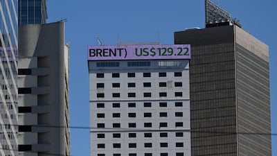 An electronic sign on a building shows the price of Brent crude oil in Hong Kong on March 9, 2022. A complete switch in energy trade from the dollar would only dent, not end, its dominance. AFP