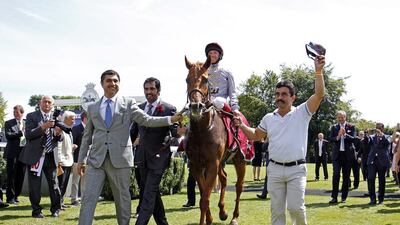 Jockey Frankie Dettori celebrates with trainer Jassim Al Ghazali, right, while aboard Dubday after winning the Betfred Glorious Stakes in Goodwood, England on July 31, 2015. Steven Cargill / Racingfotos.com