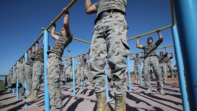 Cadets go through the paces during a group pull-ups session. EPA