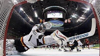 Thomas Greiss, the Germany goaltender, stretches to block a shot against Canada during their qualification game.