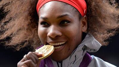 Serena Williams poses with her gold medal after defeating Maria Sharapova 6-0 6-1 at London 2012