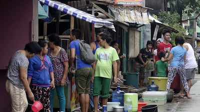 Filipino villagers collect water in Surigao, Mindanao. Dozens of aftershocks continue to rattle the city since a 6.5-magnitude earthquake struck the city on Friday, killing six. Cerilo Erbano / EPA