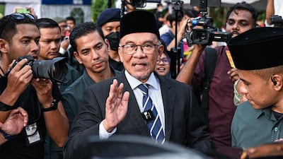 Malaysian opposition leader Anwar Ibrahim waves after meeting Malaysia's King, Sultan Abdullah, at the National Palace in Kuala Lumpur on Tuesday. AFP