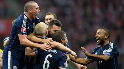 Scotland players react after Steven Naismith's goal against Poland in a 2-2 draw in Euro 2016 qualifying on Tuesday in Warsaw. Janek Skarzynski / AFP / October 14, 2014