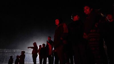 Lifeguards and firefighters rescue a migrant in Playas de Tijuana, Baja California State, Mexico. AFP