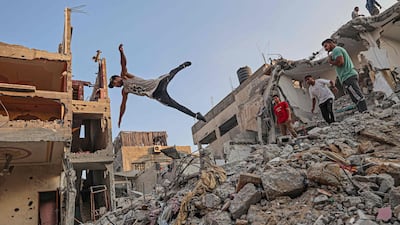 Palestinian youths practise parkour amid the rubble of buildings destroyed by Israeli airstrikes in the latest round of fighting between Israel and Palestinian militants, in Rafah in the southern Gaza Strip. AFP