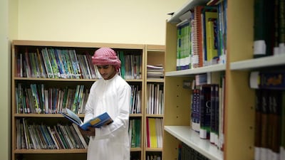 A student at Al Ittihad Model School reads a book in the library. Philip Cheung / The National