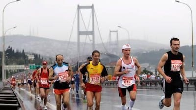 Participants run across the with Bosporus bridge during the Eurasia marathon in Istanbul, Turkey, one of the 2020 Olympics candidates.