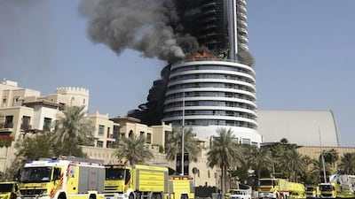 A fire burns on the Address Downtown skyscraper in Dubai, United Arab Emirates on Friday, Jan. 1, 2016. The blaze began Thursday night before Dubai's annual New Year's Eve fireworks show at the Burj Khalifa, the world's tallest building which sits nearby. (AP Photo/Sunday Alamba)