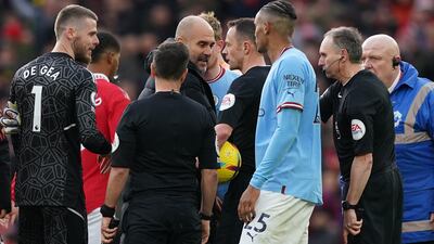 Pep Guardiola confronts referee Stuart Attwell and the assistant referee after Manchester City's defeat to Manchester United. PA