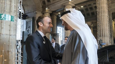 A picture posted on Sheikh Mohamed's Twitter page shows him and Mr Macron embracing, with the French leader wearing a Year of Zayed pin.