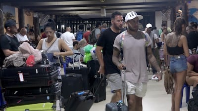 Foreign tourists with their belongings wait as their flights to leave the island of Samui have been cancelled following a tropical storm Pabuk weather warning, at an airport of Koh Samui Island, Surat Thani province, southern Thailand. EPA