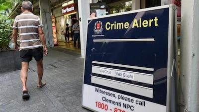 A police crime alert signboard at a public housing estate in Singapore. Authorities in Australia, Malaysia and Singapore are warning citizens of the growing number of online scams this Valentine’s Day. Roslan Rahman/AFP