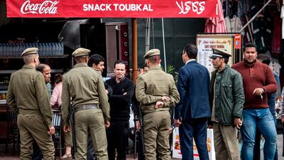 Members of the Moroccan Interior Ministry Auxiliary Forces ask owners of a restaurant to close down, in Marrakesh. AFP