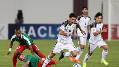 Sebastian Tagliabue, centre, was on target twice for Al Wahda against Al Wehdat. Pawan Singh / The National