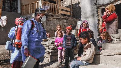 Doctor Akay Kaya and a nurse Yildiz Ayten, from the Bahcesaray public hospital vaccination team, speak to inhabitants at the village of Guneyyamac in eastern Turkey, as part of a Covid-19 vaccination drive. AFP