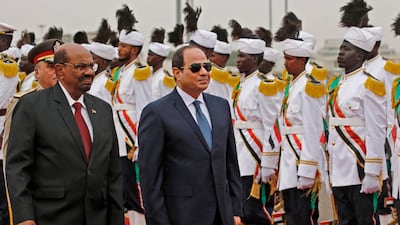 Omar Al Bashir inspects a guard of hounour with Egyptian President Abdel Fattah El Sisi at Khartoum International Airport on October 25, 2018. AFP