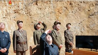 This image made from video of a news bulletin aired by North Korea on July 4, 2017, shows North Korea leader Kim Jong-un (C) watching the launch of a Hwasong-14 intercontinental ballistic missile. KRT / AP Video