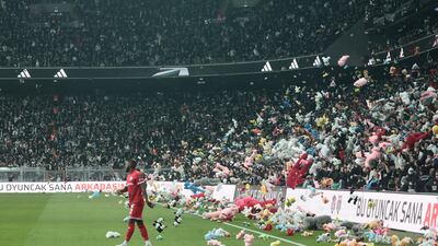Fans throw toys on the pitch for children affected by earthquake during a Turkish Super League match between Besiktas and Antalyaspor. Reuters