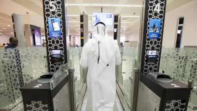 Passengers pass through the newly implemented E-Border gate, part of the smart travel system, at the Abu Dhabi International Airport in Abu Dhabi on April 13, 2016. Christopher Pike / The National